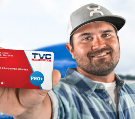 Truck driver holding his CDL fuel card by TVC Pro-Driver, the best fuel card for truckers and fleets that is accepted at over 15,000 locations