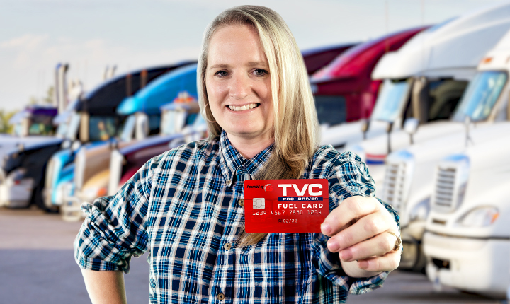 Female truck driver holding TVC fuel card.