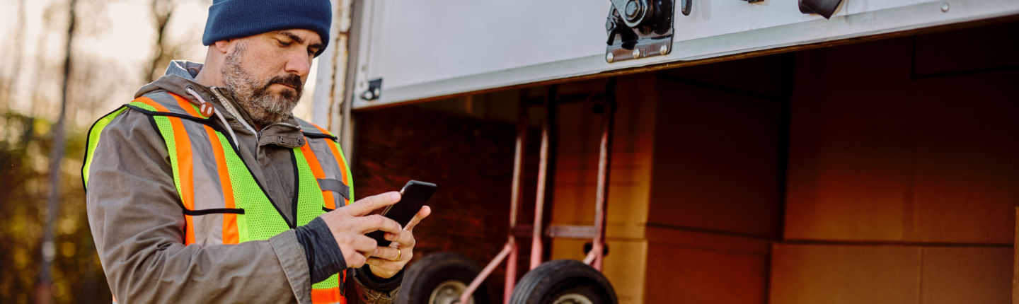 Chauffeur de camion vérifiant son téléphone